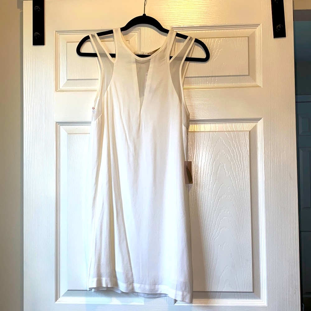 White shift dress above the knee. Never been worn.